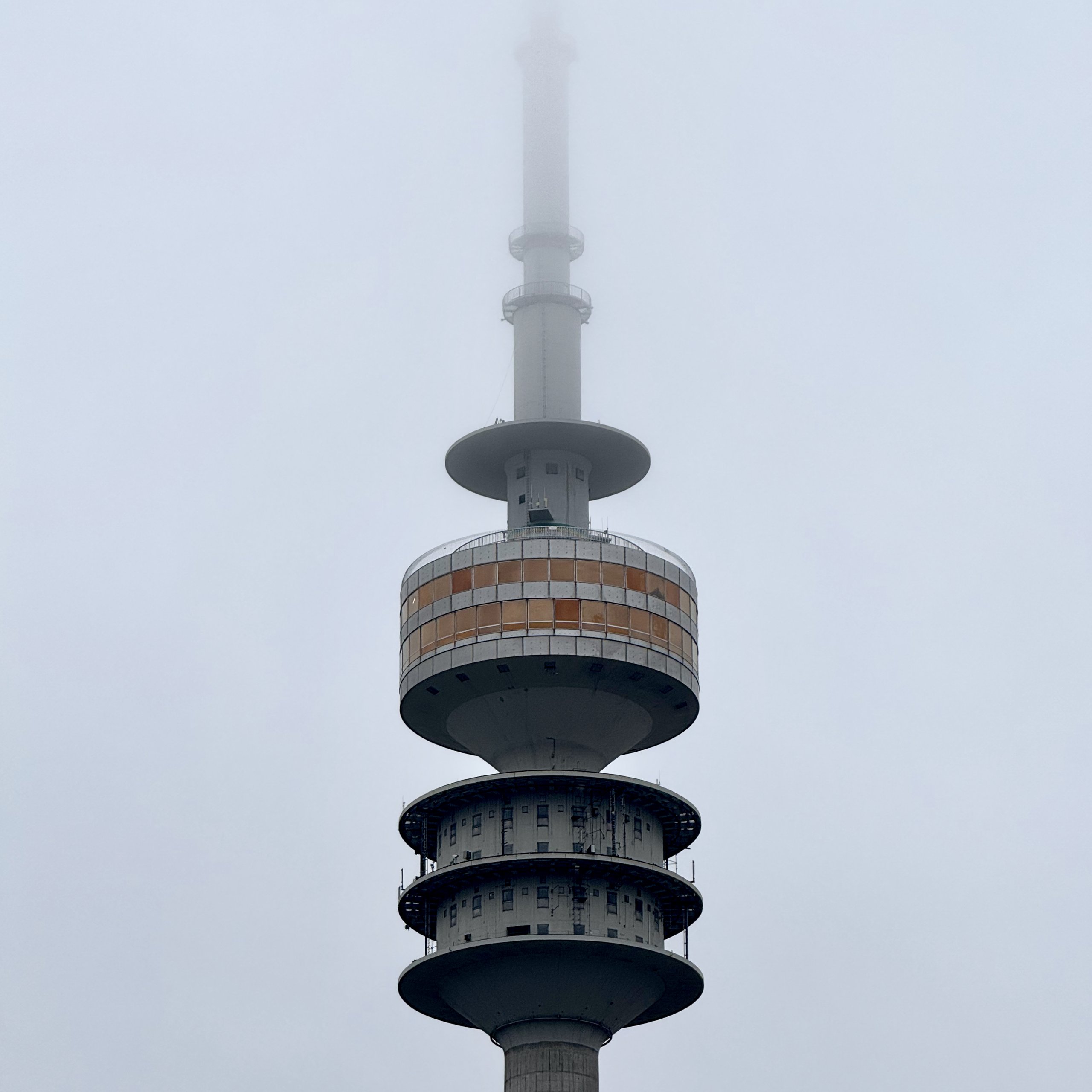 The head of Munich's Olympic tower, its mast lost in fog
