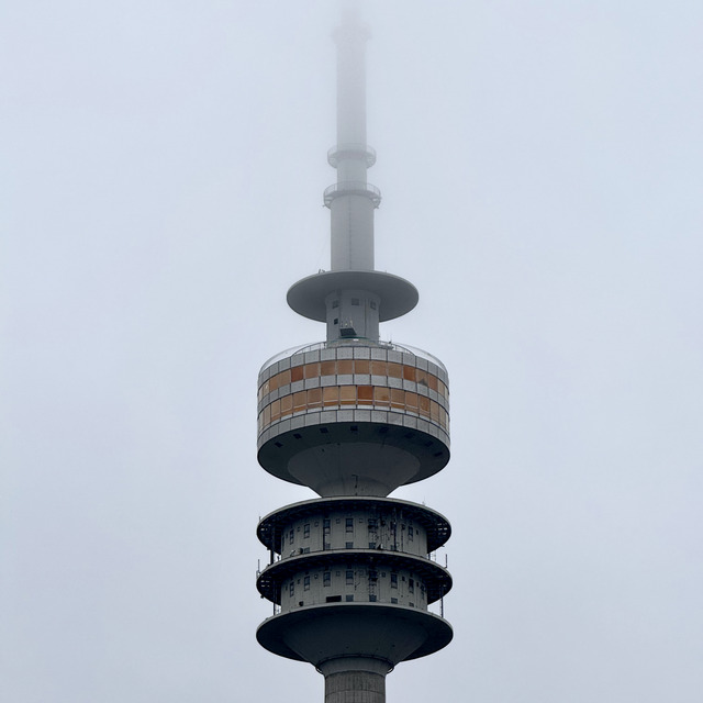 The head of Munich's Olympic tower, its mast lost in fog