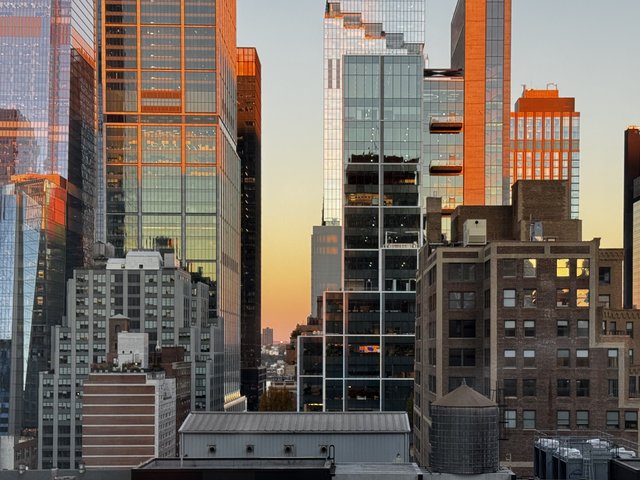 First light catches the glass of Midtown West
