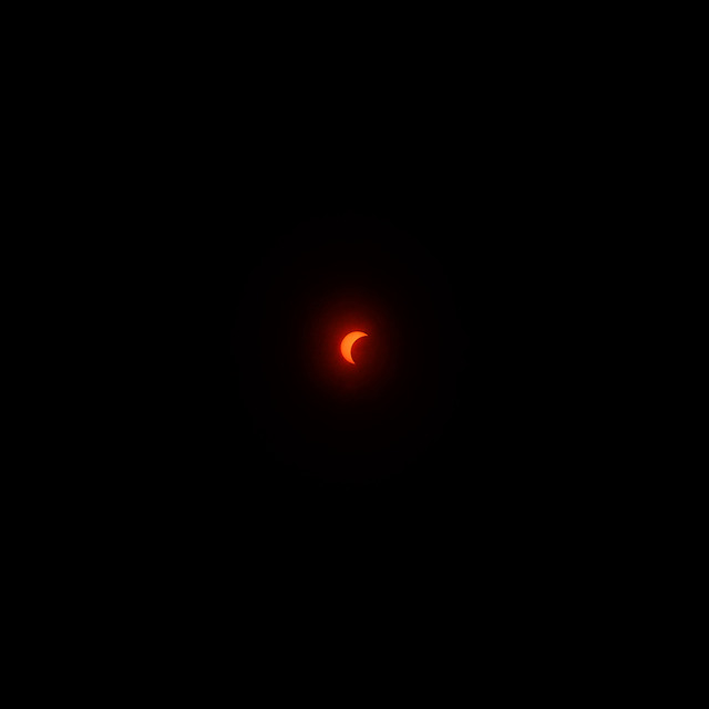 The 12 August 2026 solar eclipse: an orange crescent of sun alone in a black sky