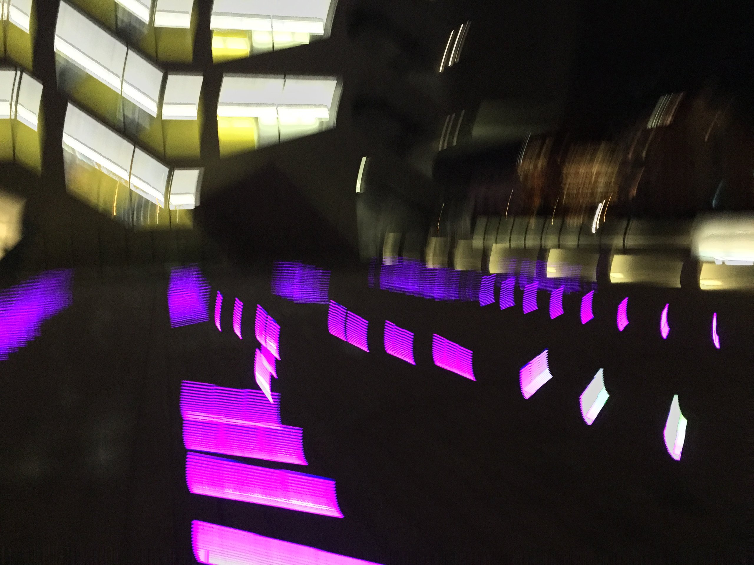 Blurred magenta and yellow light panels, camera motion turning them to streaks