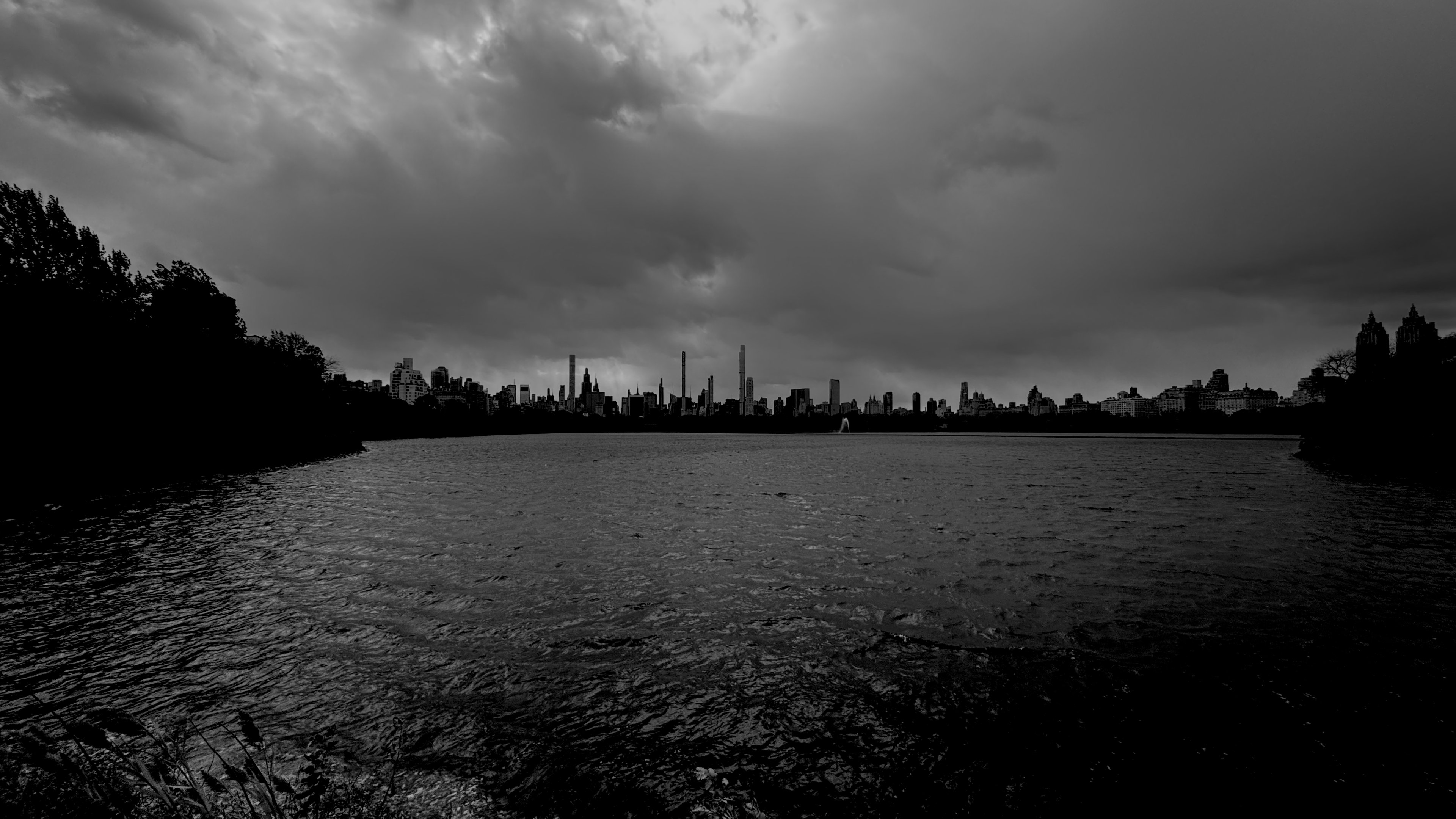 Storm light over the Central Park reservoir, the skyline in silhouette