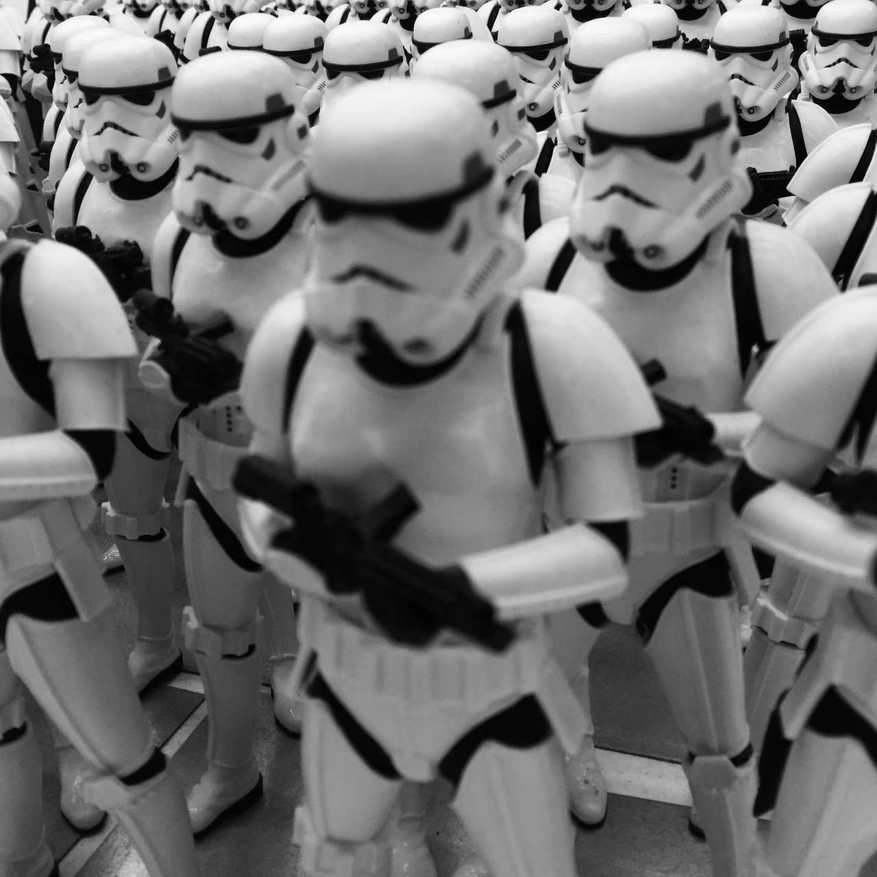Massed stormtrooper figures in ranks, monochrome, shallow focus