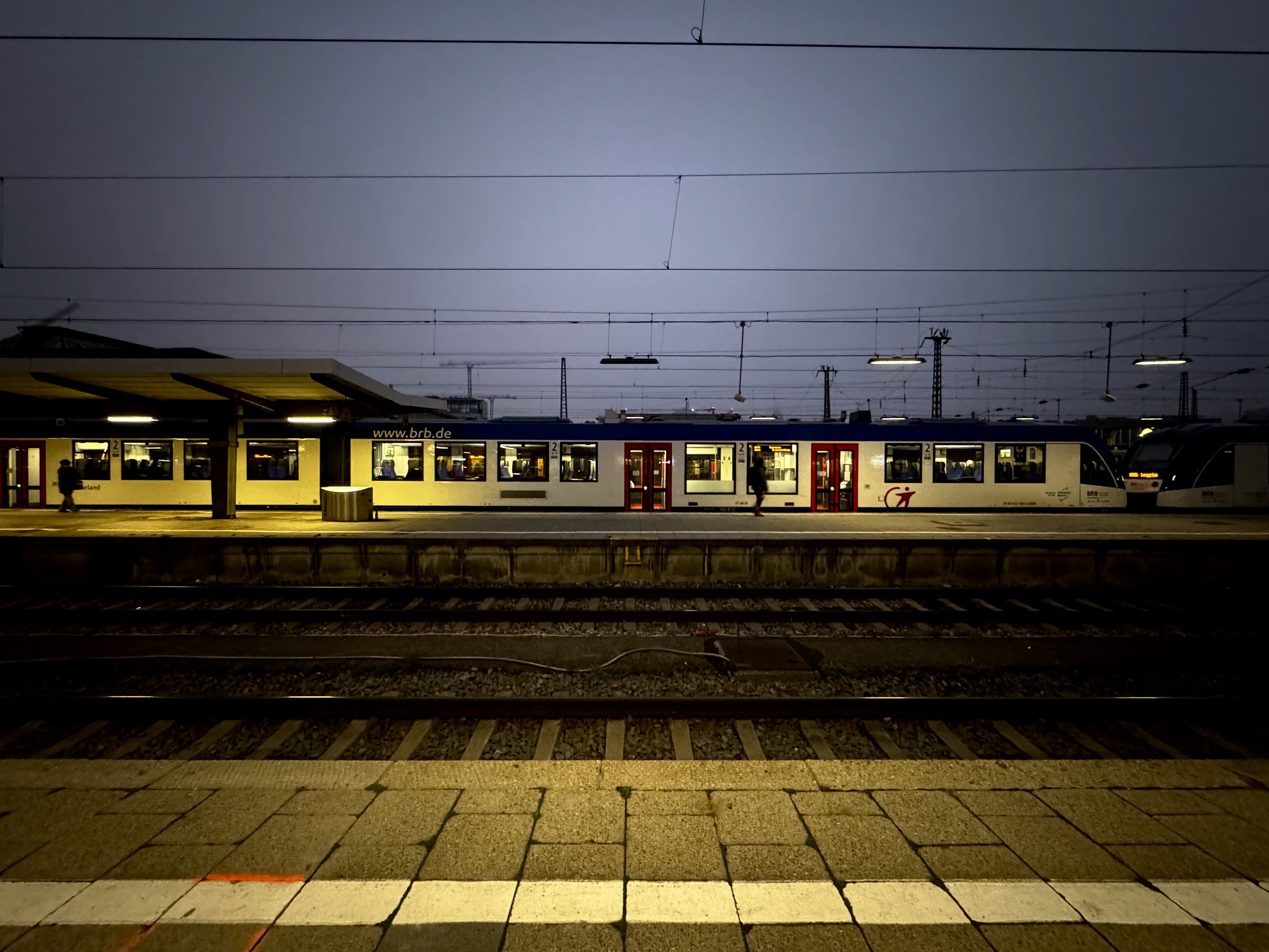 A regional train waits at a Munich platform before dawn