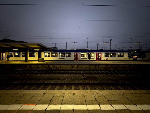 A regional train waits at a Munich platform before dawn