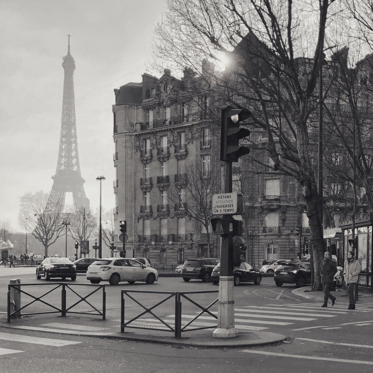 A Paris crossing with the Eiffel Tower hazy beyond