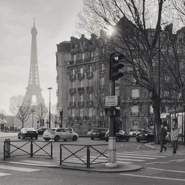 A Paris crossing with the Eiffel Tower hazy beyond