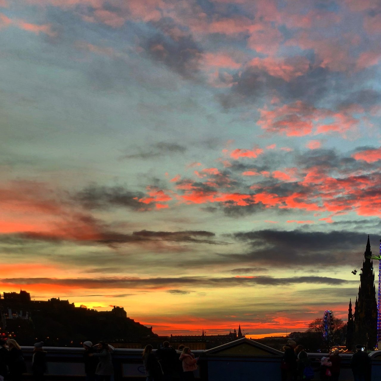 Fiery sunset over Edinburgh, monument and castle in silhouette