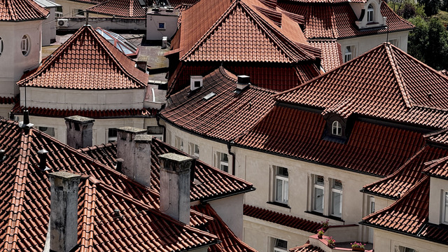 Terracotta rooftops, chimneys and dormers of Prague seen from above, packed edge to edge
